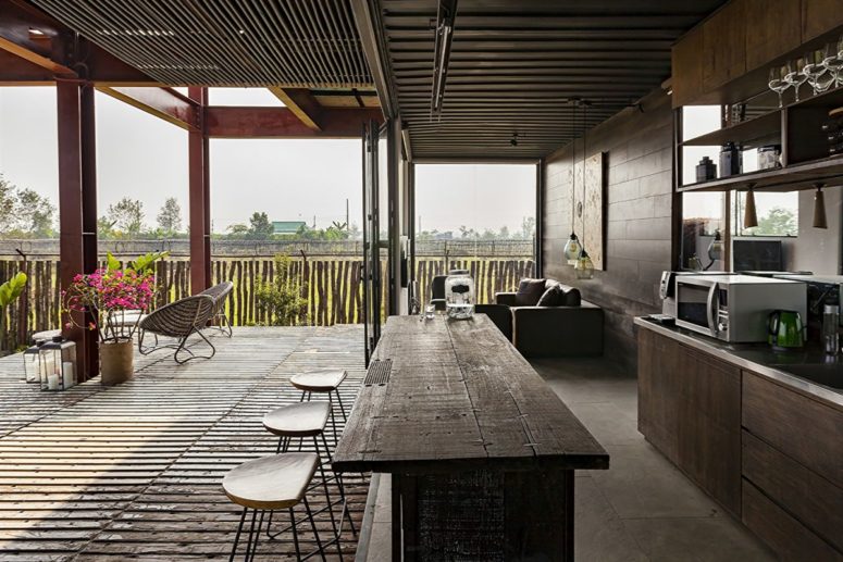Reclaimed wood and metal were widely used throughout the residence, and all the spaces can be opened to outdoors
