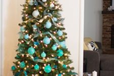 05 a bold ombre Christmas tree from white to turquoise and blue with lights and ribbons is ideal for a beach Christmas