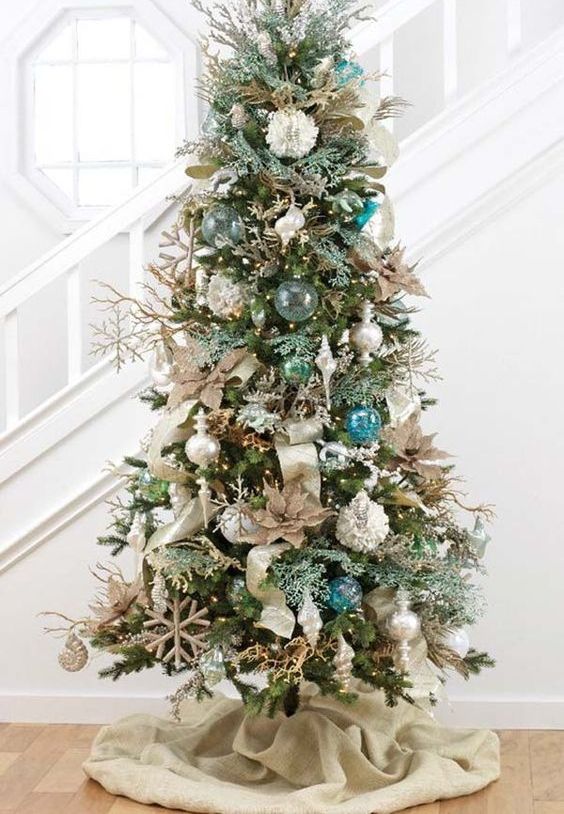 a brilliant Christmas tree with float-like ornaments, metallic ornaments and burlap decorations isn't that evidently coastal