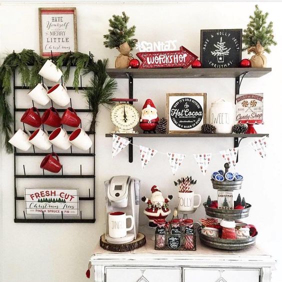 a hot coffee and chocolate station with traditional mugs, evergreens, pinecones and other cute details