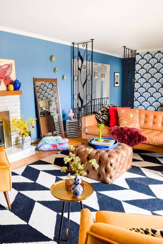 a colorful eclectic living room with modern furniture and textiles and touches of vintage