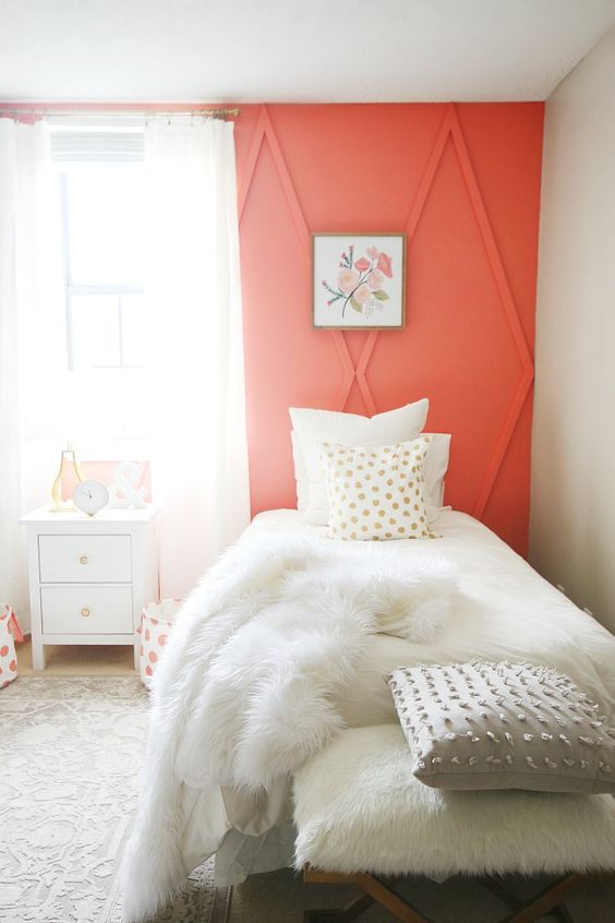 a coral architectural wall raises the guest bedroom decor to a new level and makes a colorful statement