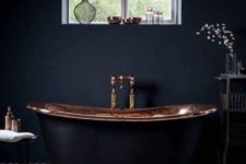 06 a moody bathroom with a fantastic black bathtub with a copper surface inside is a gorgeous idea