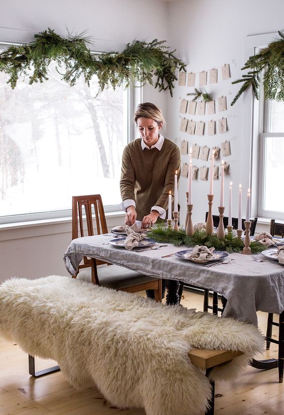 natural evergreen garlands and a matching table runner plus wooden candle holders are great for a hygge space