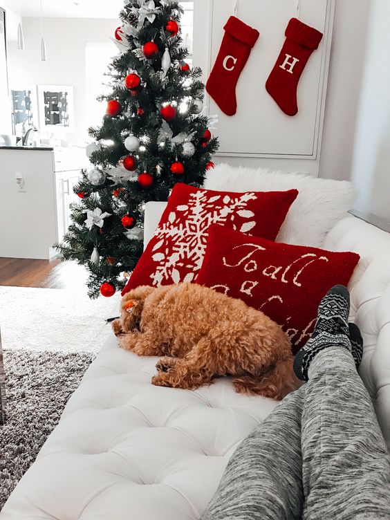 several red pillows and stockings plus ornaments are enough to make your space more holiday-like