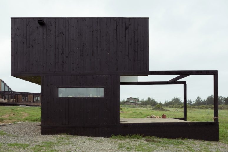 This is the second building, a black cabin with an extended deck