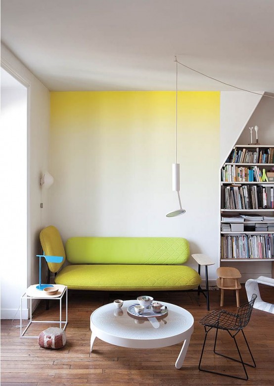 a bright ombre statement wall from yellow to neutrals and a matching neon yellow couch for a cool breakfast nook