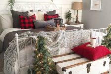 07 a vintage farmhouse Christmas bedroom with plaid pillows, fur, Christmas trees and a sign over the bed