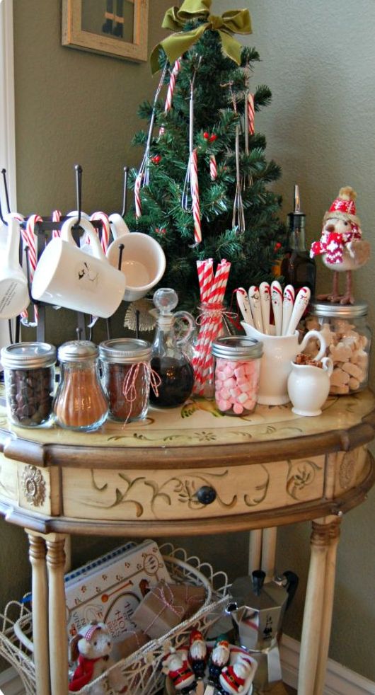 a vintage table as a hot chocolate station with sweets and a little Christmas treee in the corner