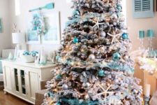 08 a flocked Christmas tree with star fish, silver and turquoise ornaments and turquoise garlands