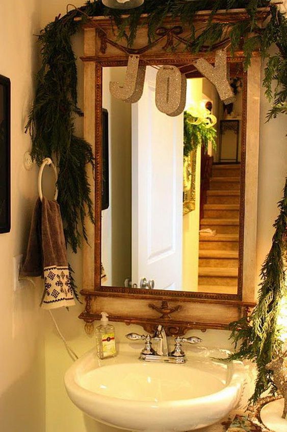 a lush evergreen garland to cover the mirror and a glitter letter garland for a holiday feel