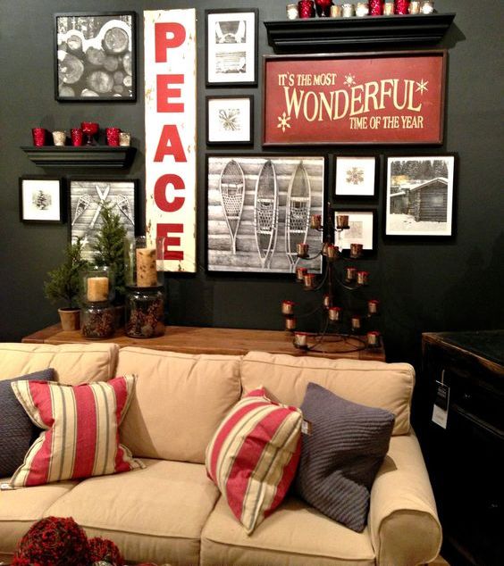 a stylish holiday gallery wall with photos, signs and candles on the shelves is a bold idea