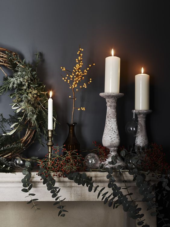 decorate your mantel with fresh greenery, berries, vines and branches and add candles for a magical feel