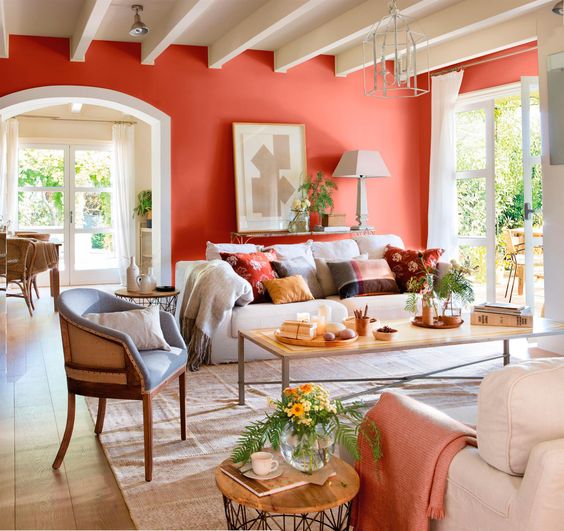 a coral statement wall brightens up and refeshes a neutral living room, a couple of matching textiles echo with it