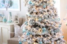 09 a gorgeous flocked coastal Christmas tree with blue and pearly ornaments plus lights and star fish