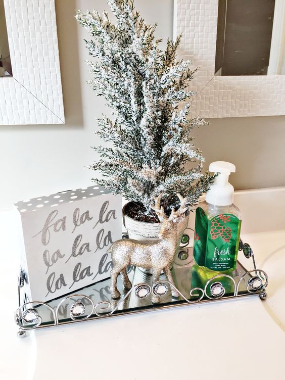 a single and simple festive display with metallic touches is a gorgeous idea to rock for Christmas bathroom decor