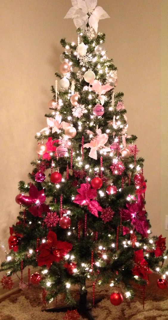 a fun and bold Christmas tree with ornments from pearl and silver to pink, hot pink and red plus lights and icicles