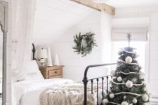 10 a vintage-inspired Christmas bedroom with a cozy bedalcover, a knit blanket, a Christmas tree with oversized ornaments