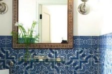 10 blue mosaic tiles in the bathroom and an ornate mirror frame are amazing for a Mediterranean bathroom