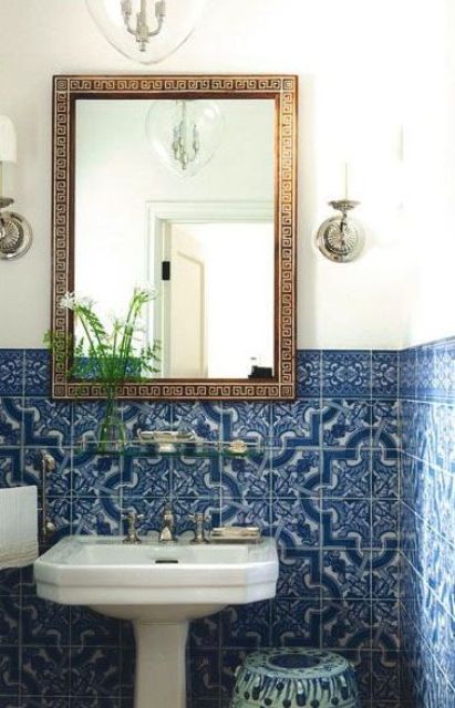 blue mosaic tiles in the bathroom and an ornate mirror frame are amazing for a Mediterranean bathroom