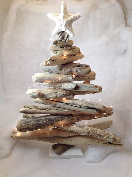 make a driftwood Christmas tree with lights and a star fish topper to decorate a mantel or a shelf