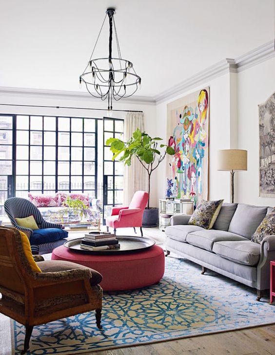 the pink chair echoes with the ottoman and pillows on the sofa to tie them all up