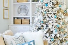 11 a chic flocked Christmas tree with turquoise and blue ornaments, star fish and fake corals, matching pillows
