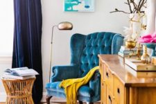 11 a yellow wooden sideboard and a turquoise upholstered chair look very harmonious together