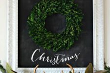 12 a boxwood Christmas wreath and a lush evergreen garland with lights, foliage, feathers and fake antlers