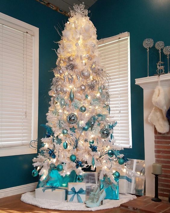a white Christmas tree with an ombre effect from white and silver to light blue and turquoise plus lights and snowflakes