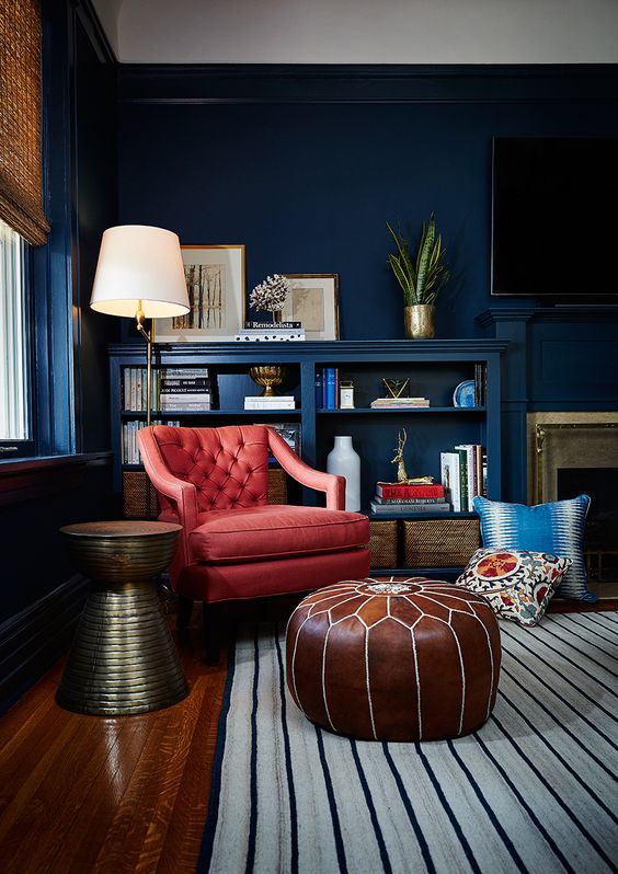 a coral diamond upholstery leather chair contrasts the bold navy space