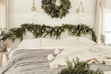 13 a cozy bedroom with natural decor – evergreen wreaths and garlands plus neutral and plaid textiles
