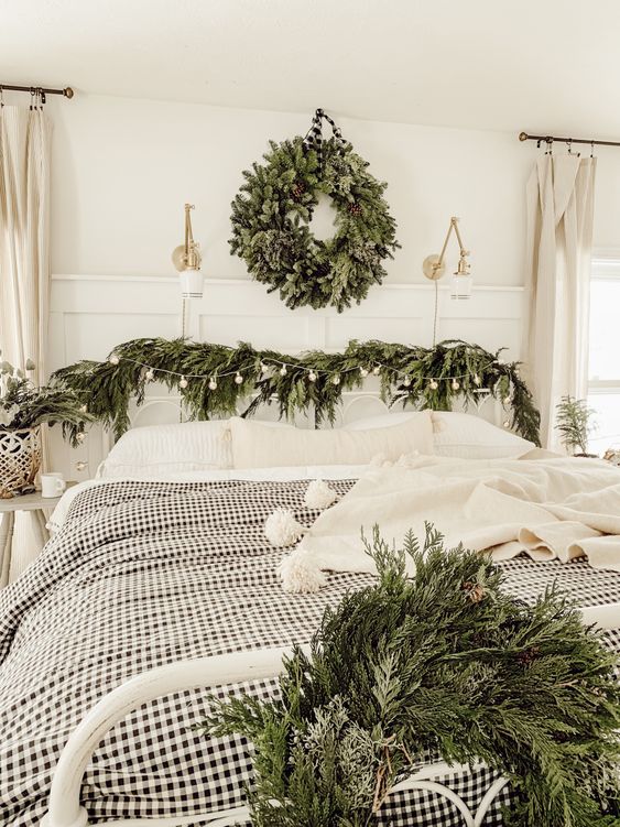 A cozy bedroom with natural decor   evergreen wreaths and garlands plus neutral and plaid textiles