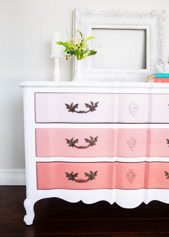 an ombre sideboard from light pink to coral with a refined vintage design and chic handles