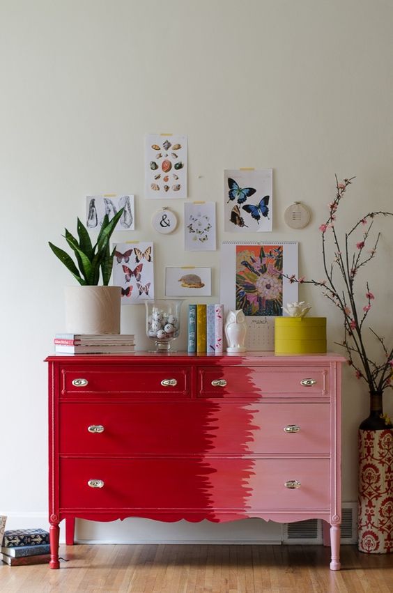 a bold red and pink dresser is a chic idea to make a statement with color in a modern way