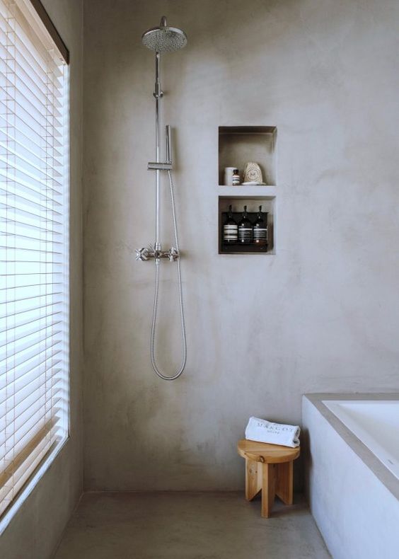 a neutral bathroom completely done with concrete is a trendy minimalist space
