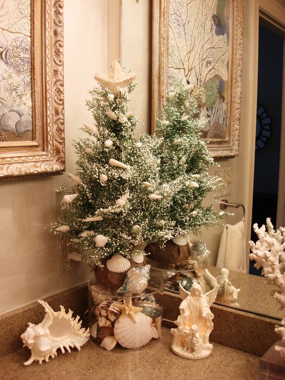 if you have a beachy bathroom, keep the holiday decor beachy, decorate your tree with shells