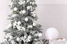 15 a silver grey Christmas tree with silver and white ornaments is a chic piece that looks frozen
