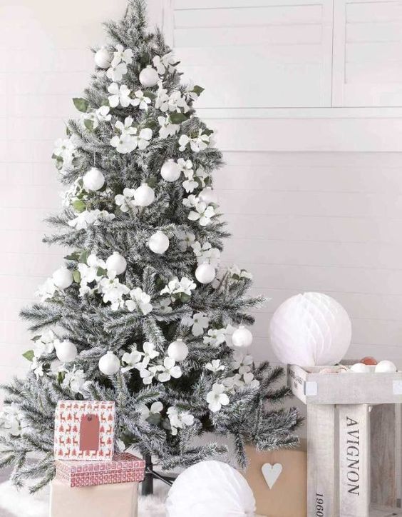 a silver grey Christmas tree with silver and white ornaments is a chic piece that looks frozen