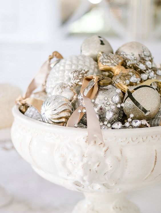a vintage bowl with silver and gold glitter Christmas ornaments for a shiny touch on your table or mantel