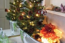 16 fill your soap bowl with lights, gifts and a Christmas tree with pinecones and lights instead of soaps