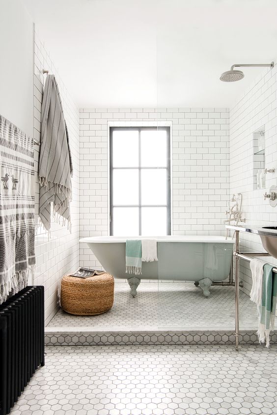 a peaceful space done with subway and hexagon tiles, accented with mint and wicker touches