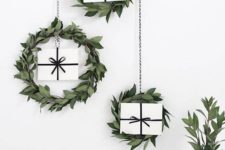 17 a trio of greenery hanging wreaths with gifts for a Scandinavian or minimalist space