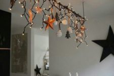 17 create an overhead decoration over the dining table and add lights to make your meals more festive