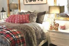 18 a cozy sleeping space with printed bedding, faux fur, a large sign with an evergreen garland
