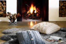 18 a faux fur rug and cable knit pillows are amazing to create a little cozy nook by the fireplace