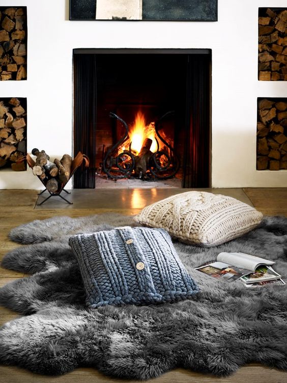 a faux fur rug and cable knit pillows are amazing to create a little cozy nook by the fireplace