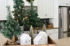18 a tray with houses, tinsel Christmas trees in burlap with lights is a cool rustic decoration