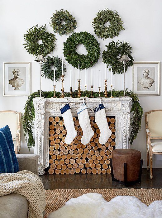 an arrangement of lush greenery wreaths and a matching garland on the mantel will brign a natural feel to the space