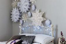 18 decorate the wall with paper snowflakes and lights to create a charming ambience while sleeping